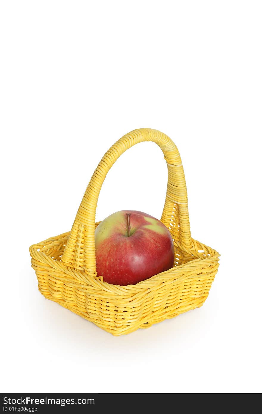 Big apple inside yellow wicker basket isolated on white. Big apple inside yellow wicker basket isolated on white