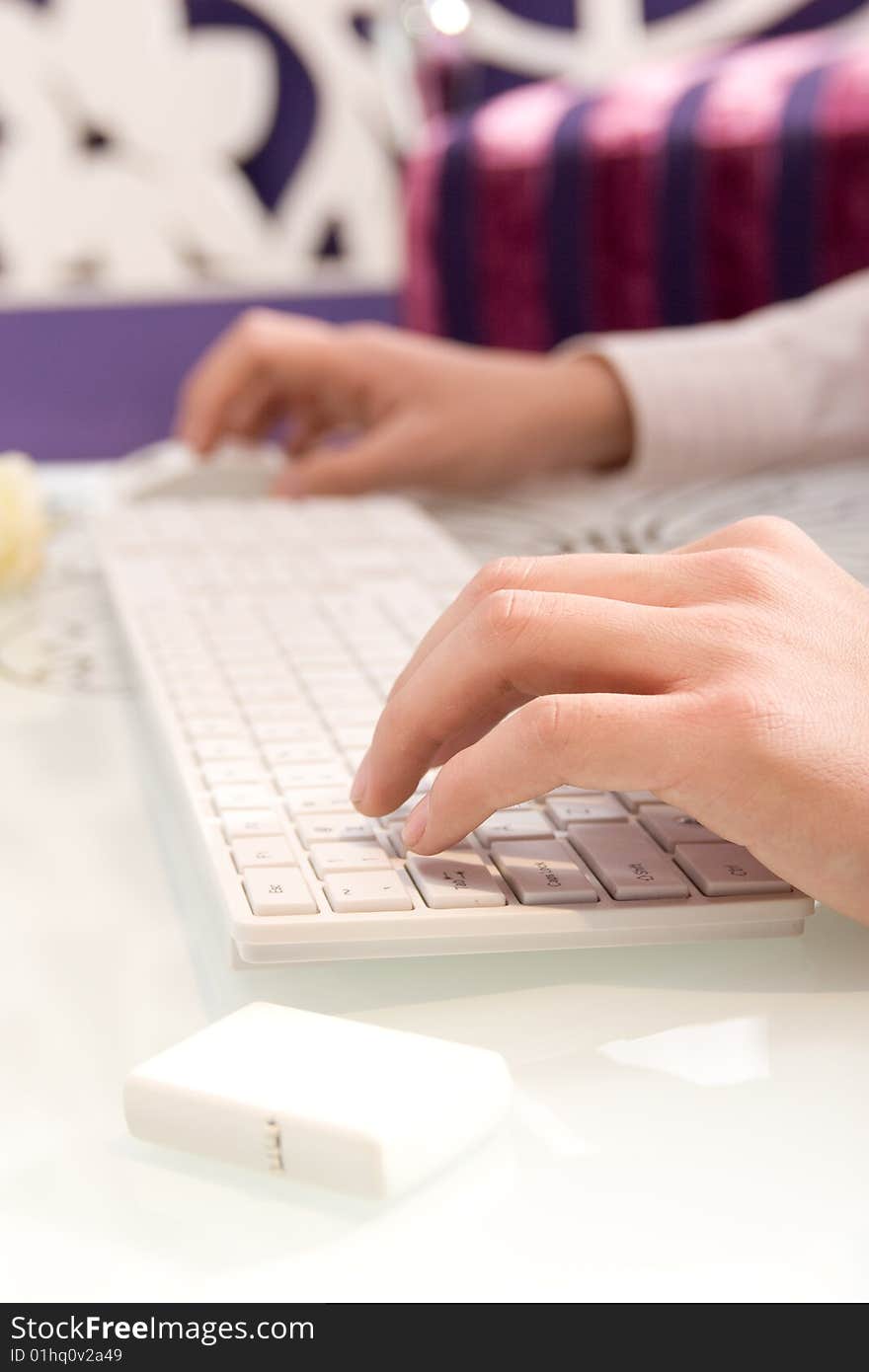 Businesswoman working on white keyboard