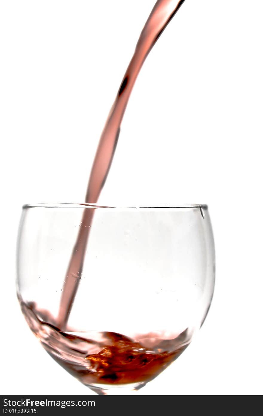 Pouring wine into a glass on a white background. Pouring wine into a glass on a white background