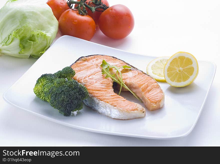 Fresh salmon cooked with tomato salad broccoli salad. Fresh salmon cooked with tomato salad broccoli salad