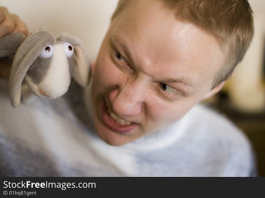 The boy holds a toy - a rabbit out of the cartoon Hunting Season. The boy holds a toy - a rabbit out of the cartoon Hunting Season