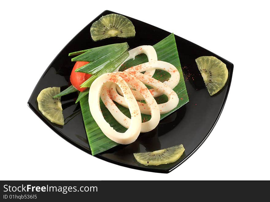 Rings of squid on black plate