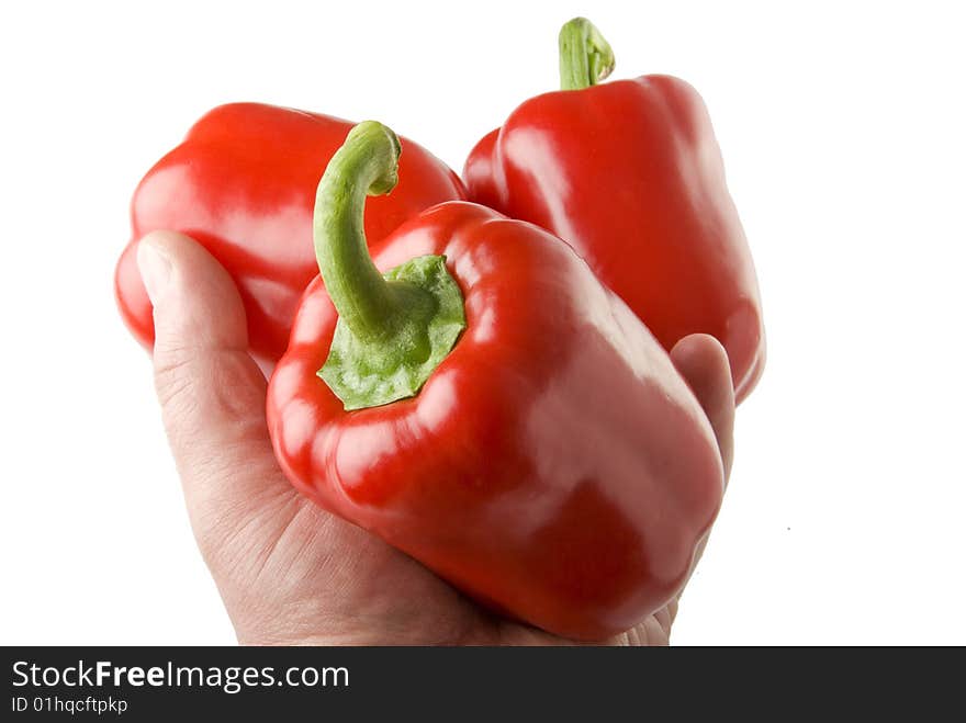 There are a red sweet peppers on the white background. There are a red sweet peppers on the white background