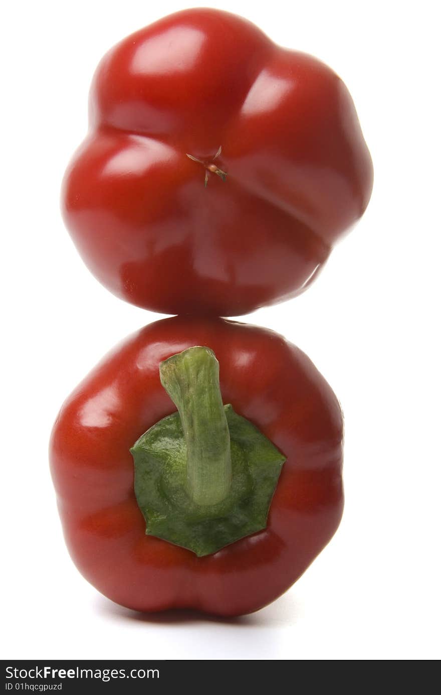 There are a red bulgarians sweet peppers on the white background. There are a red bulgarians sweet peppers on the white background