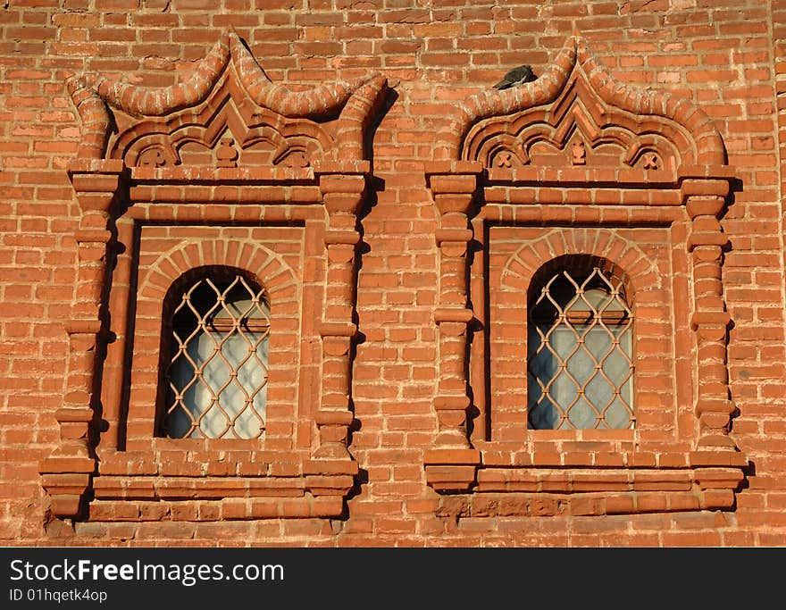 Two windows on brickwall