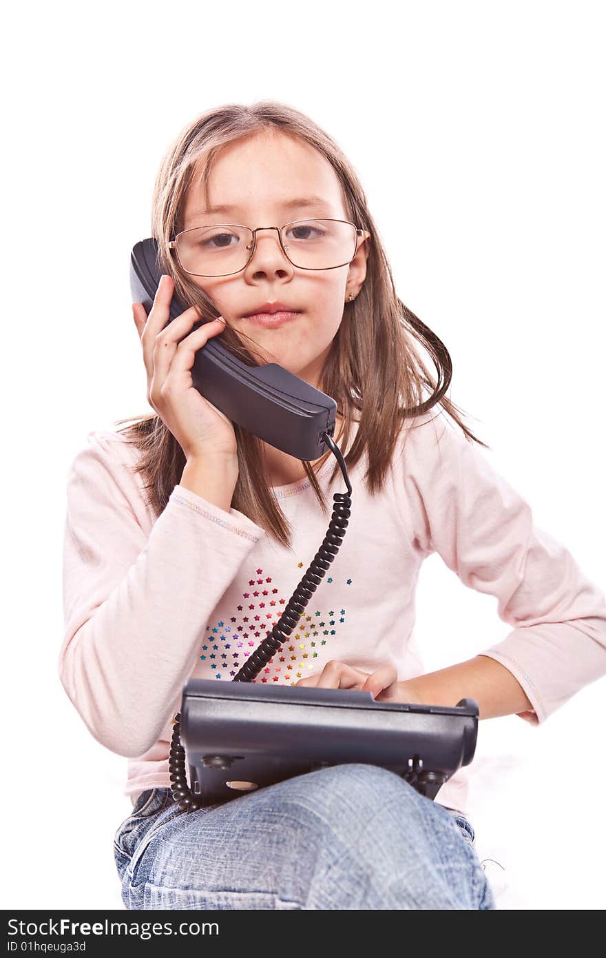 Studio photo of little girl with telephone