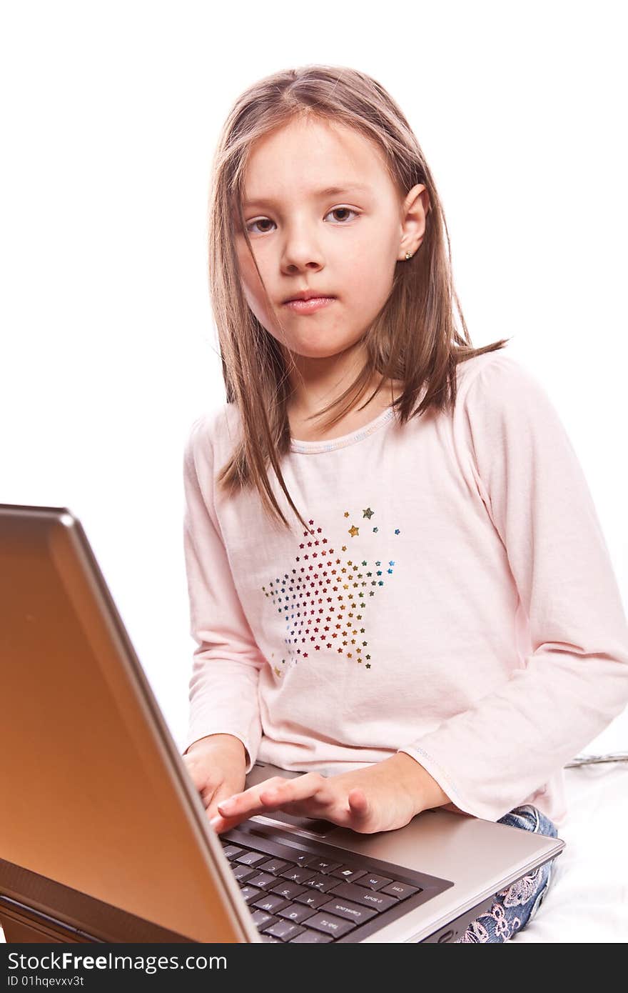 Studio photo of little girl with laptop