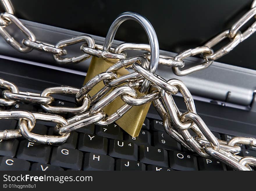 Laptop keyboard secured with chain and padlock