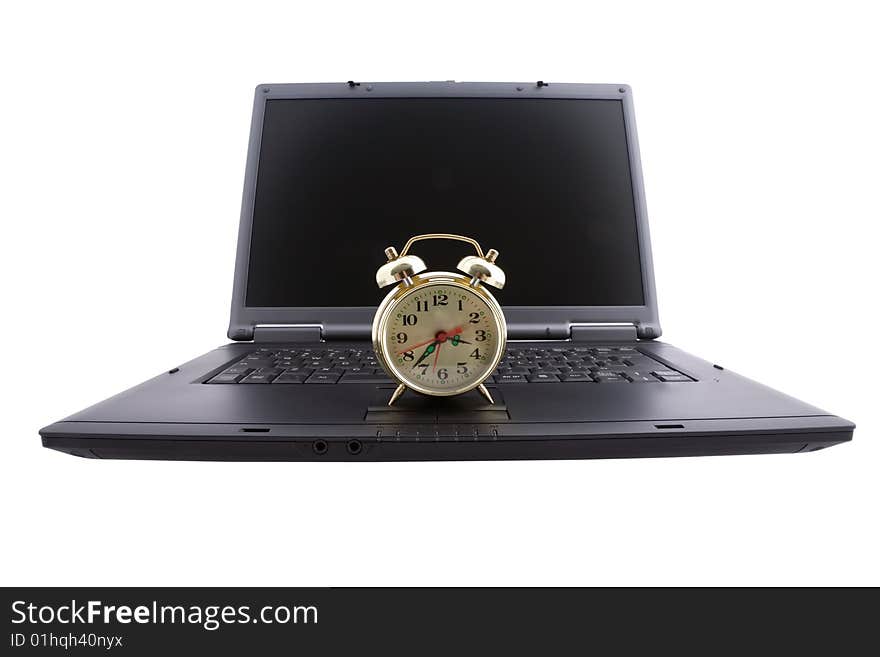 Black laptop and alarm clock. Black laptop and alarm clock