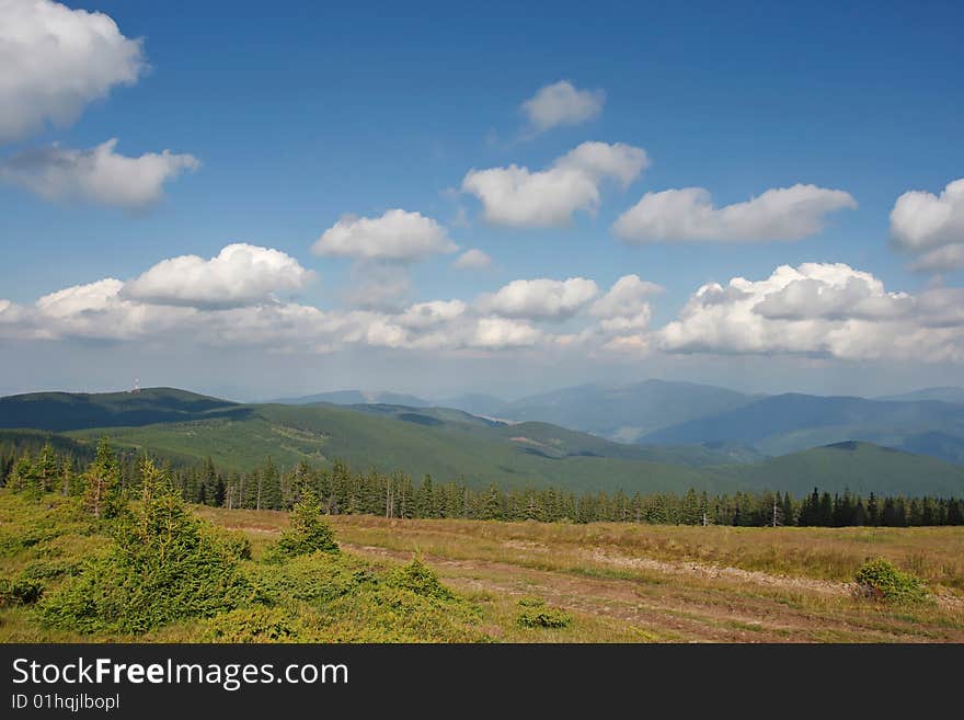 Mountain landscape with fluffy clouds