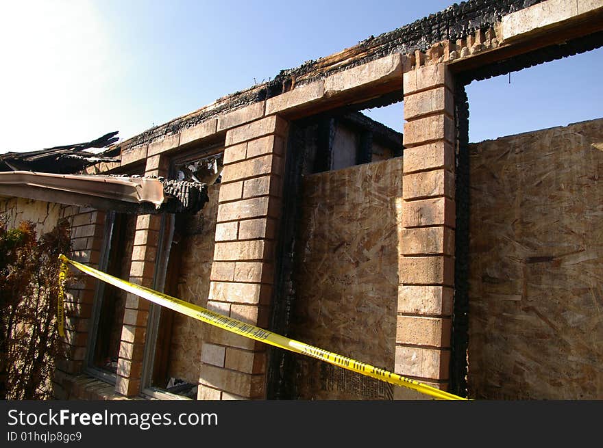 The remaining shell of a home destroyed by fire. The remaining shell of a home destroyed by fire.