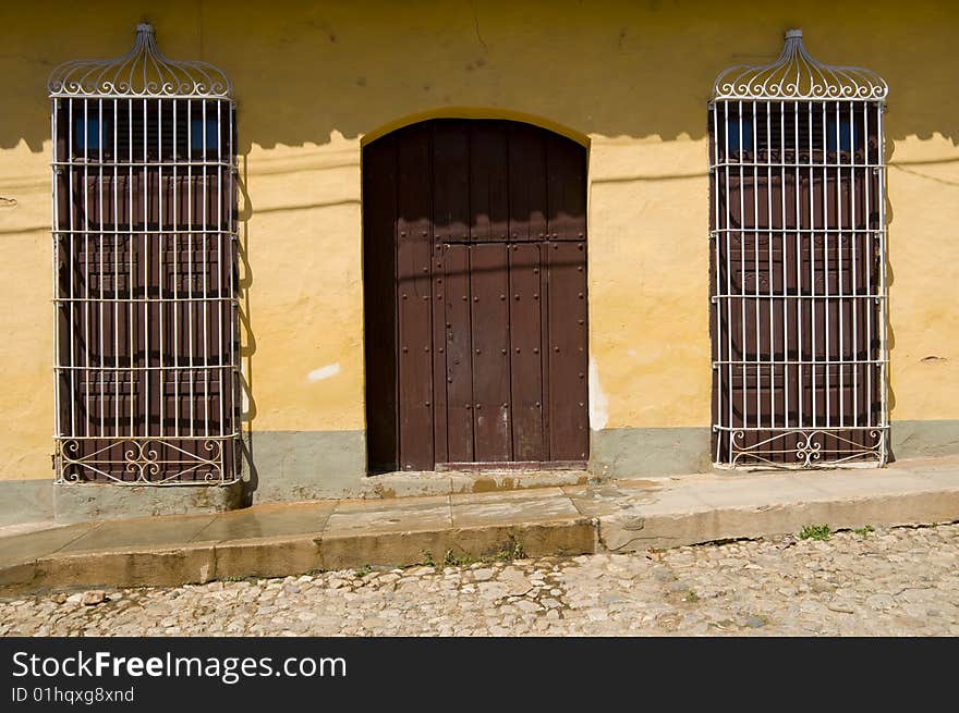 The entrance to a Spanish colonial era house on a cobbled street in Trinidad, Cuba. The entrance to a Spanish colonial era house on a cobbled street in Trinidad, Cuba.