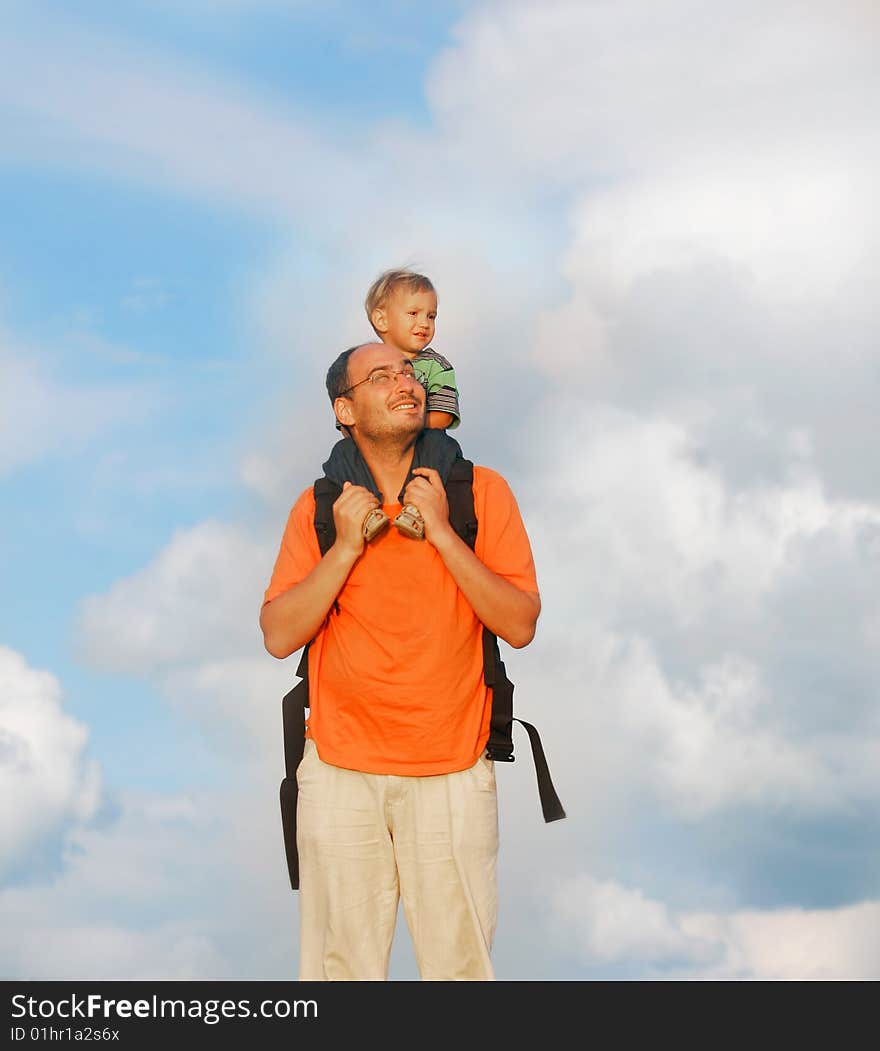 Father and son on sky background