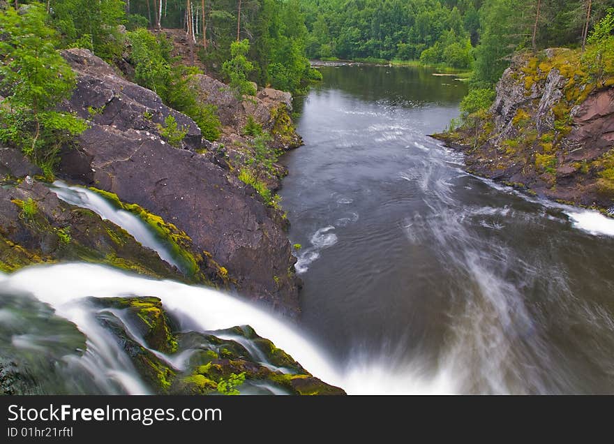 Waterfall and green forest near lake. Waterfall and green forest near lake