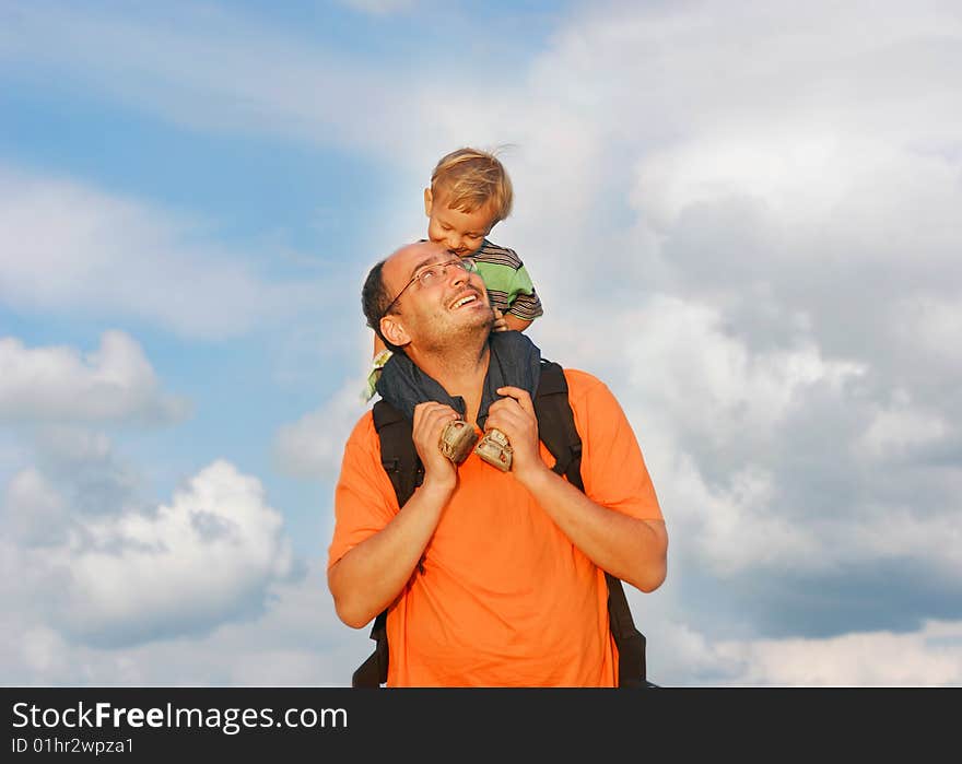 Father and son on sky background