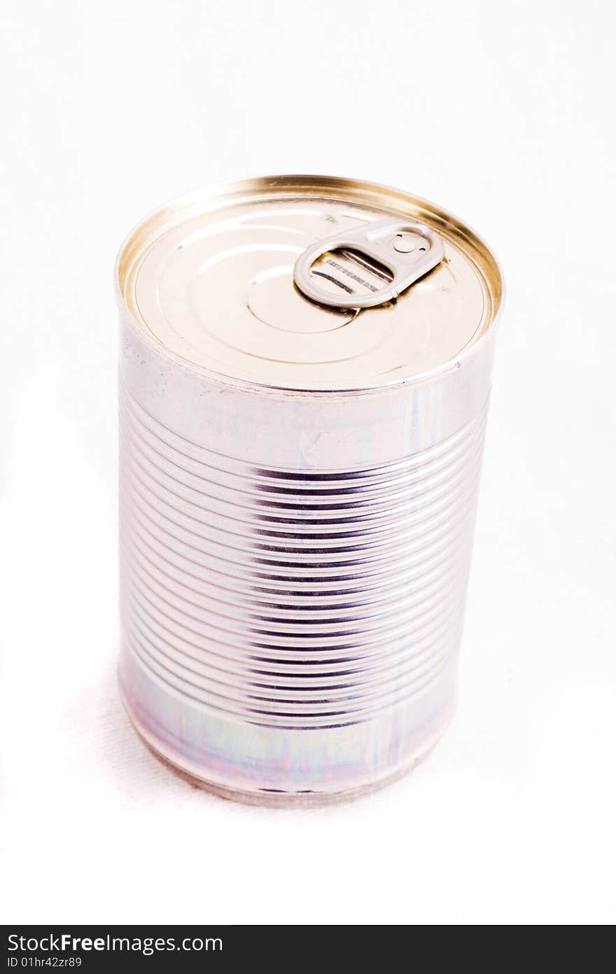 A single unopened tin can over white. A single unopened tin can over white