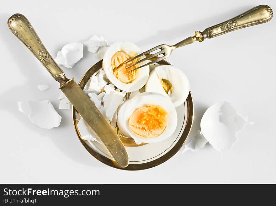 Egg on a white plate with knife and fork. Egg on a white plate with knife and fork