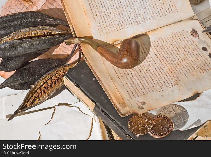 Old ancient book with pipe and old money. Old ancient book with pipe and old money