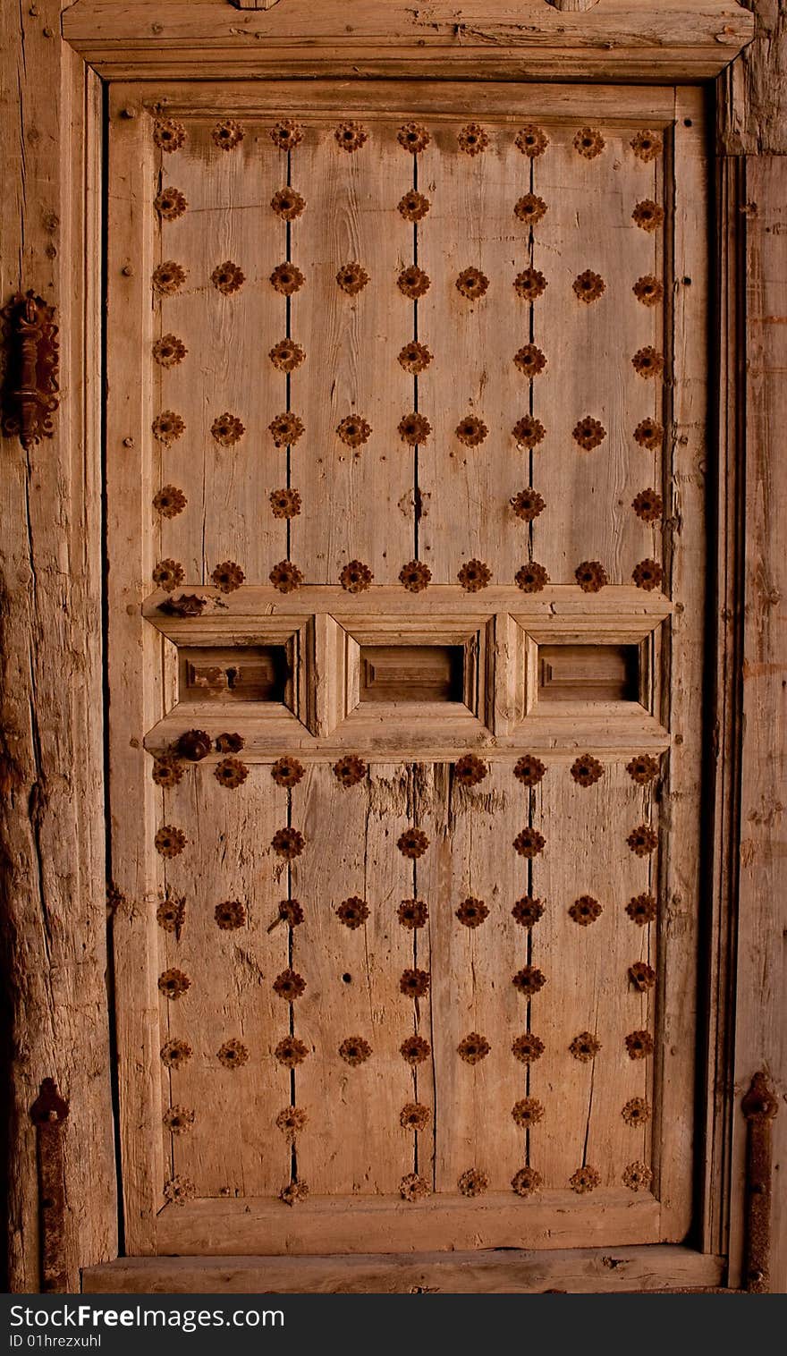 Very old wooden door with metal reinforcements. Very old wooden door with metal reinforcements