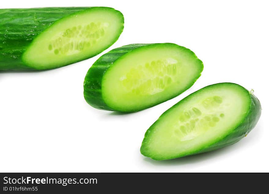 Slices of fresh green cucumber isolated on a white background