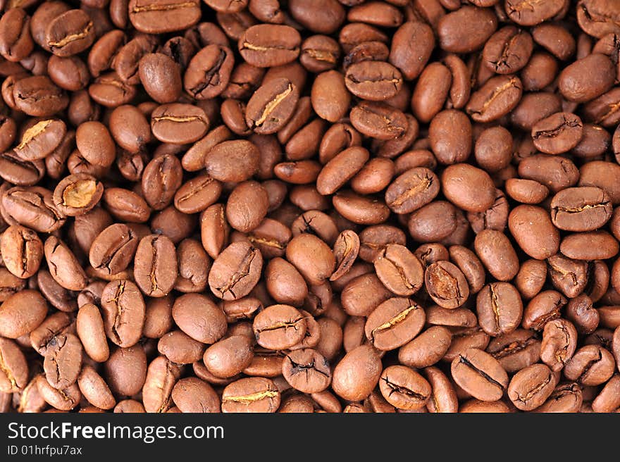 Many brown coffee grains background