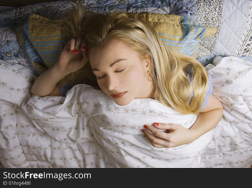 Girl sleeping or relaxing in bed - bedroom scene. Girl sleeping or relaxing in bed - bedroom scene