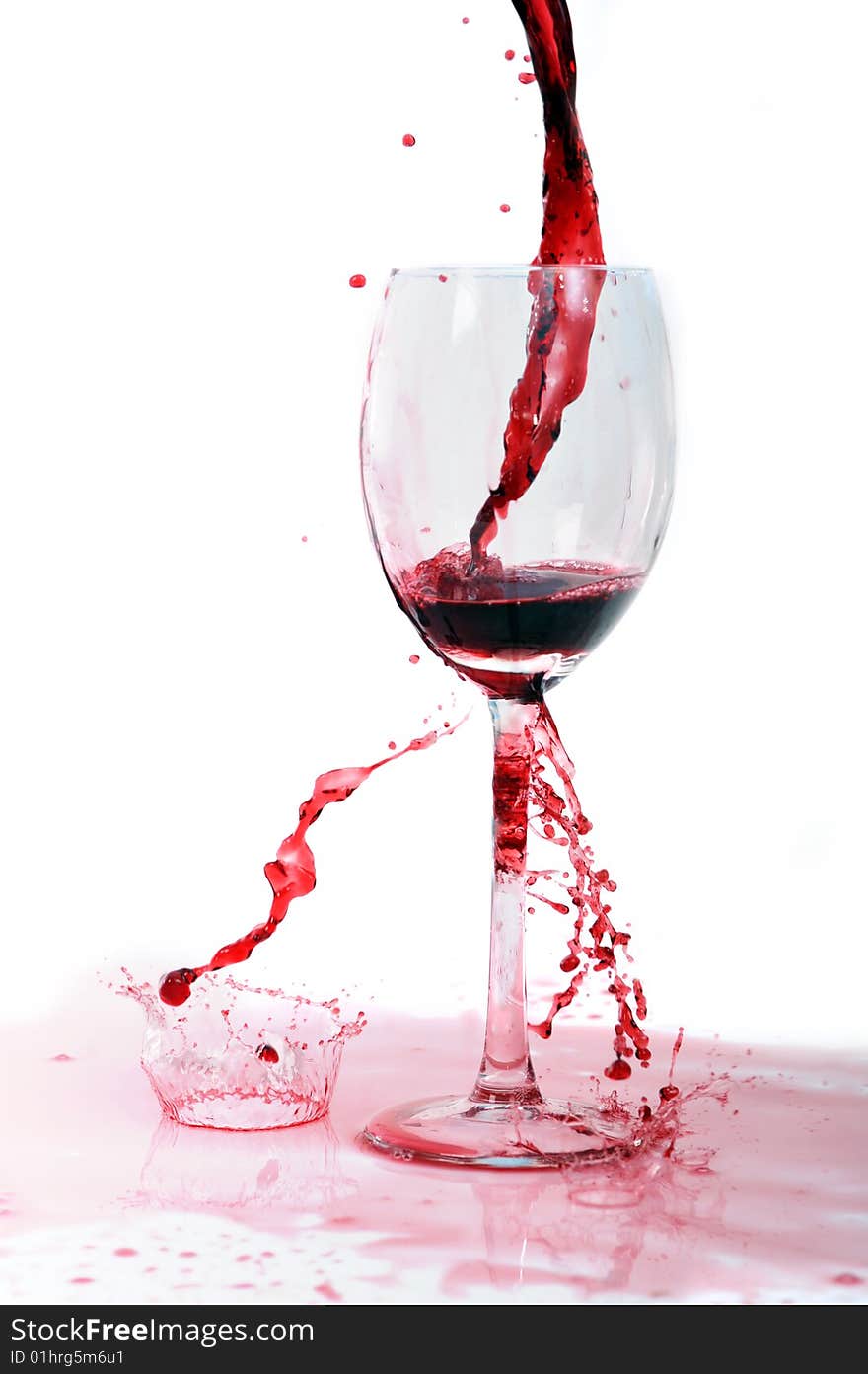 Red wine flowing in transparent glass