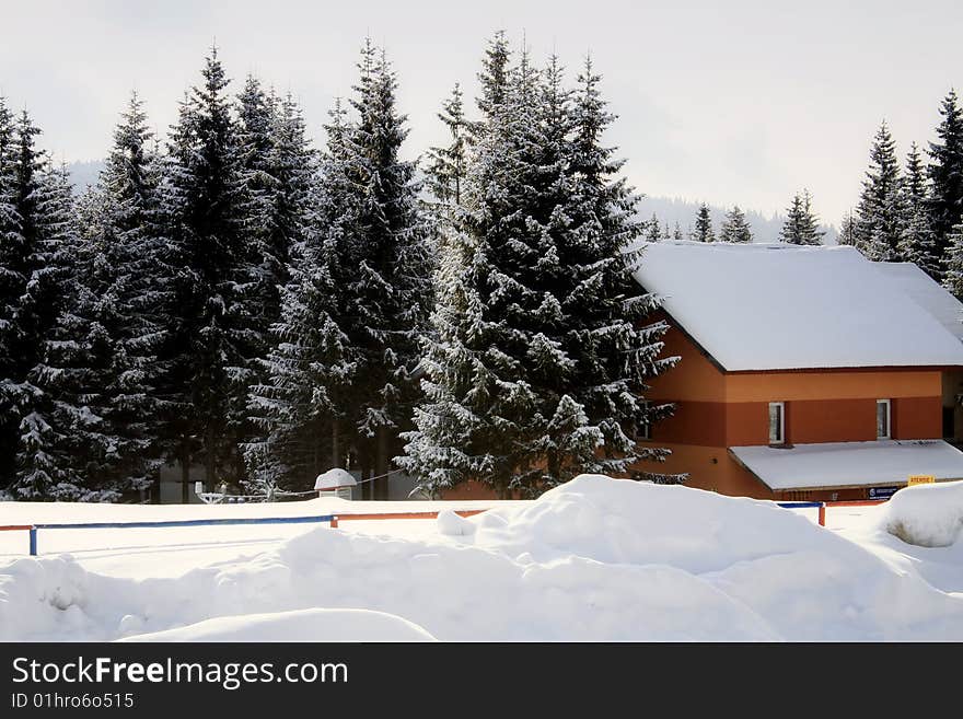 Lodge covered with snow at the sore of Bolboci Lake,Bucegi Mountains. Lodge covered with snow at the sore of Bolboci Lake,Bucegi Mountains