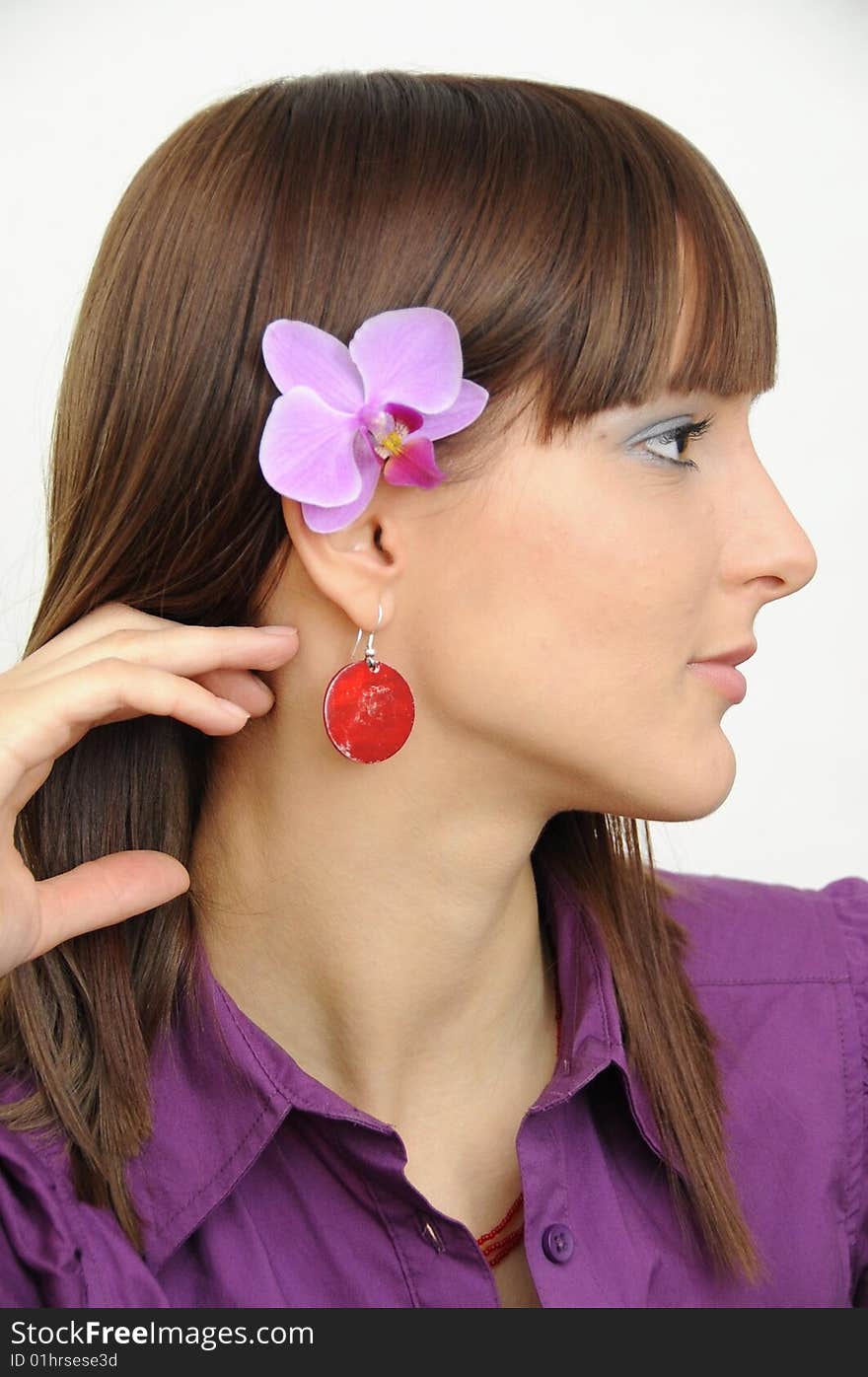 Portrait in profile of a beautiful young girl with flower behind her ear. Portrait in profile of a beautiful young girl with flower behind her ear