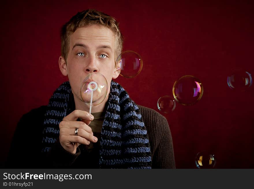 Handsome young blonde man blowing a bubbles. Handsome young blonde man blowing a bubbles