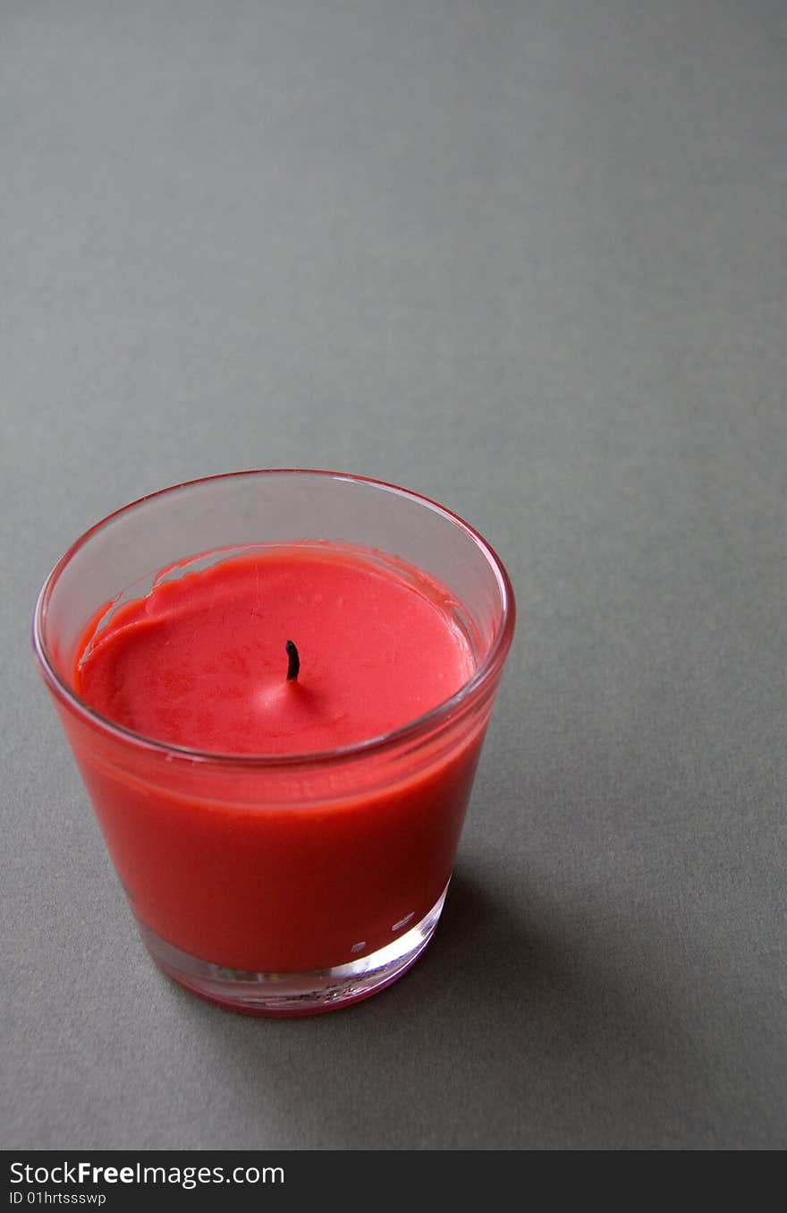 Red Candle against the Green Background