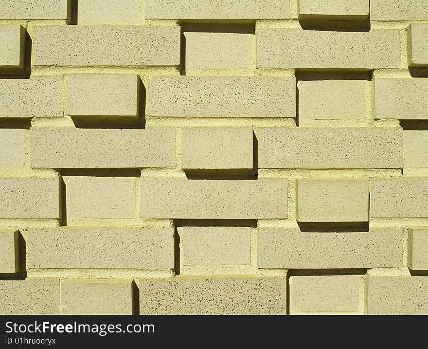 A pastel yellow multi-layered and multi-sized brick wall. A pastel yellow multi-layered and multi-sized brick wall.