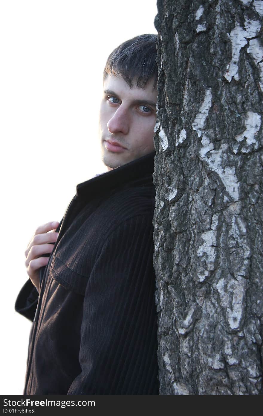 One beauty young guy with white tree. One beauty young guy with white tree