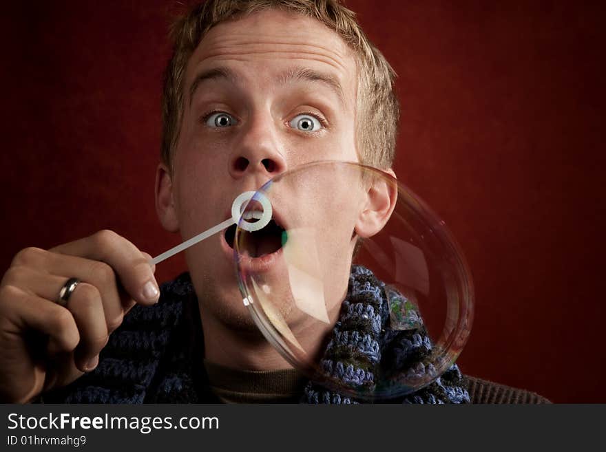 Young Man Blowing A Bubble