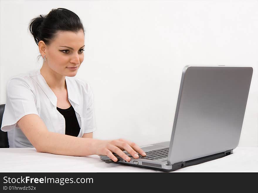 Young doctor is looking the laptop, isolated in white background. Young doctor is looking the laptop, isolated in white background