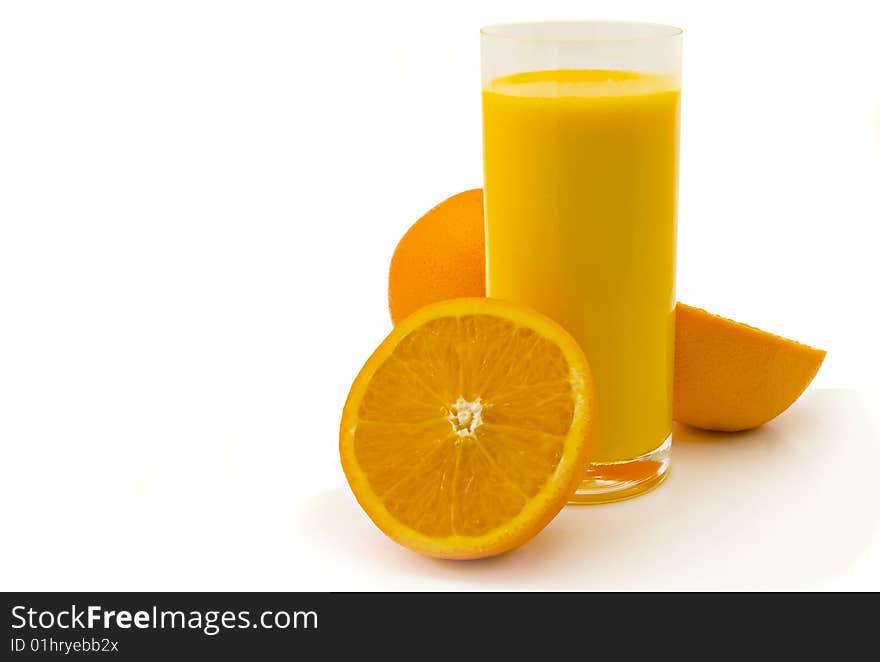 Glass of orange juice and oranges on a white background