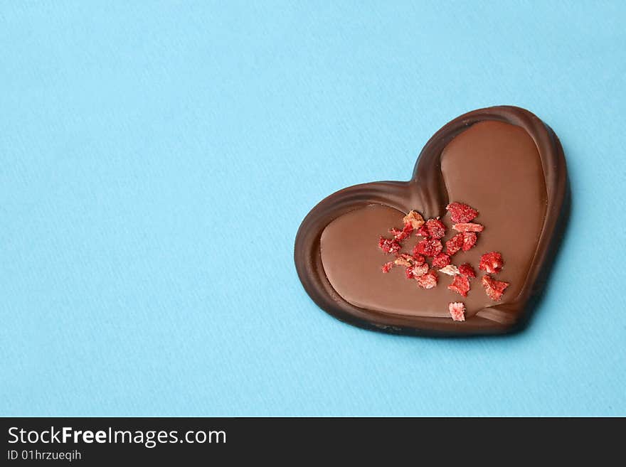 Chocolate heart on the blue background. Chocolate heart on the blue background.