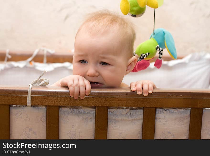 Adorable nine months old blond  baby in bed