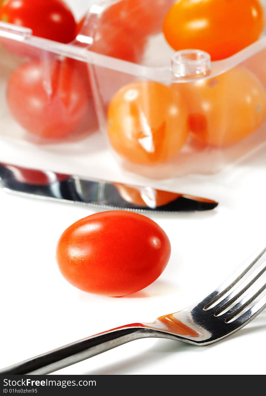 Fork and Knife with Cherry Tomato. Isolated on White Background