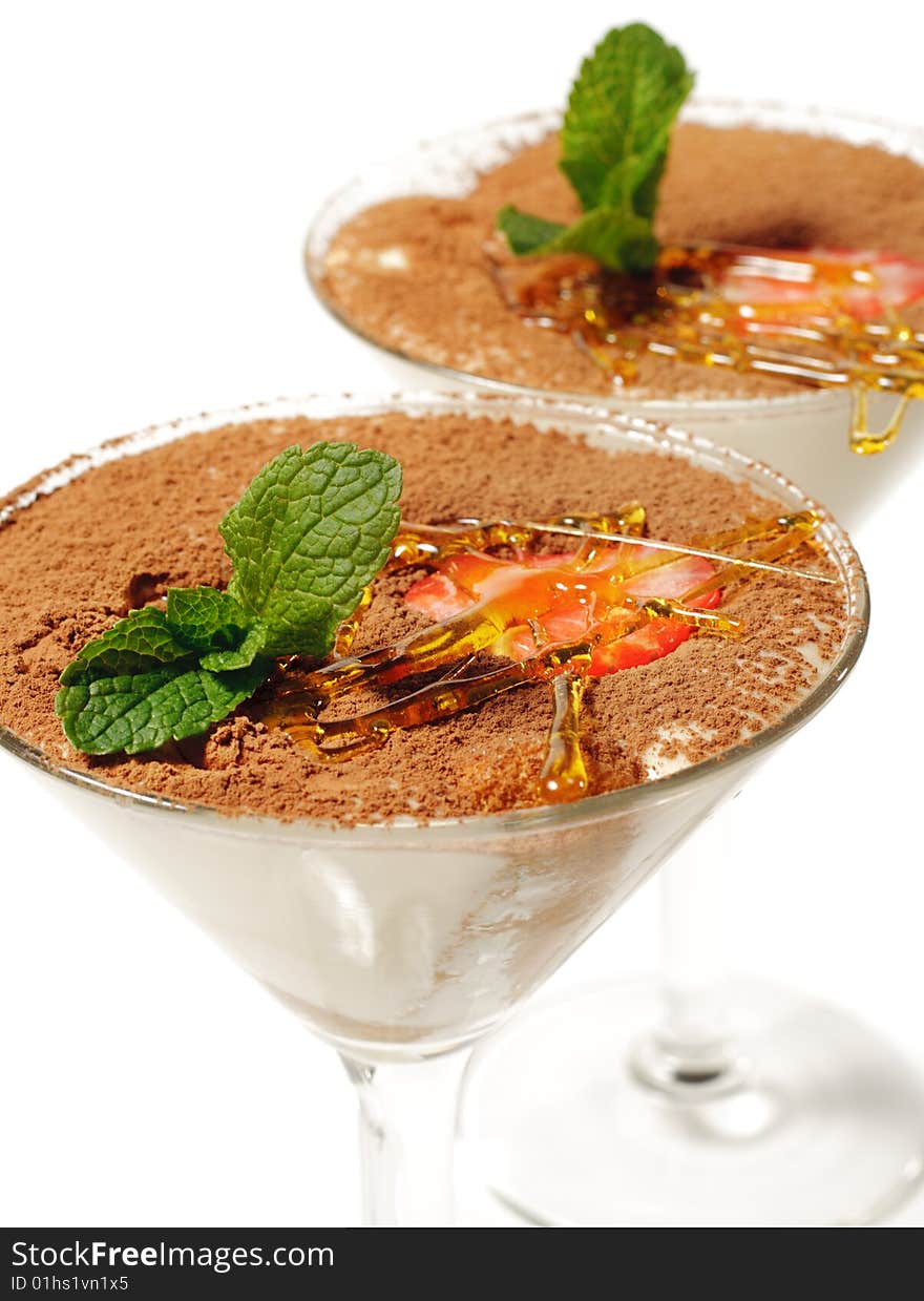 Tiramisu Dessert in a Glass with Mint and Strawberry. Isolated on White Background