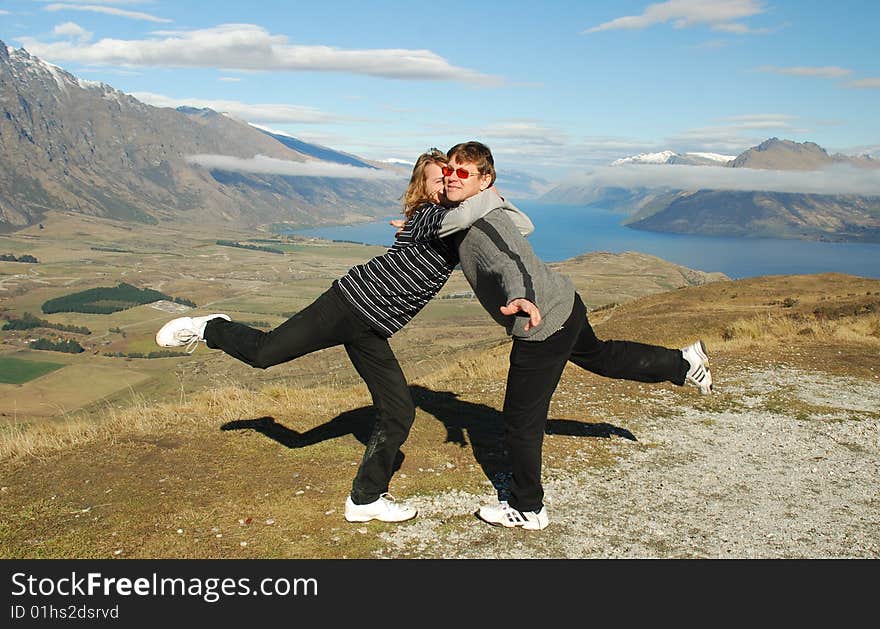 Father and teenage son playing and having fun together in a mountain setting. Father and teenage son playing and having fun together in a mountain setting