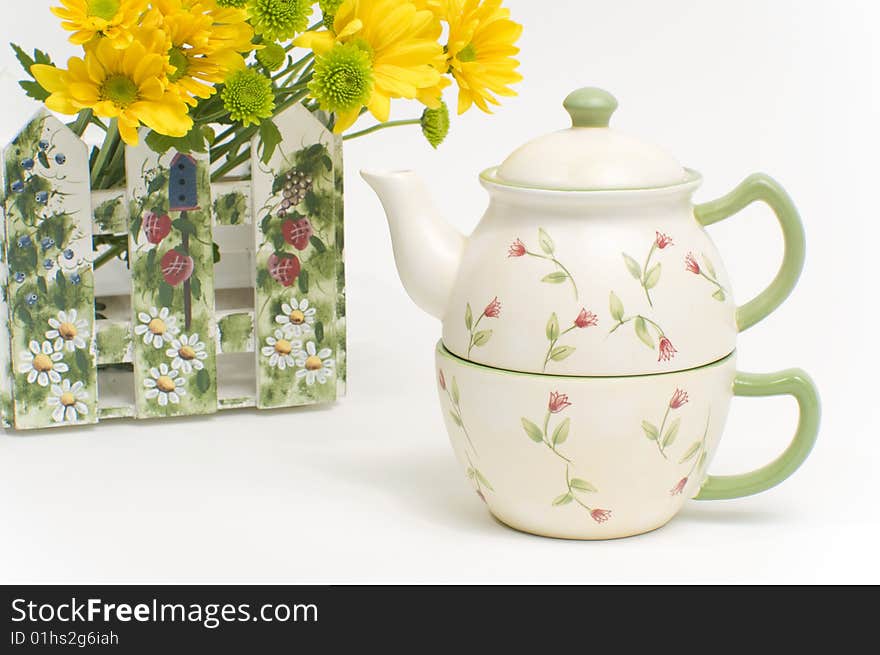 Teapot and cup with yellow flowers