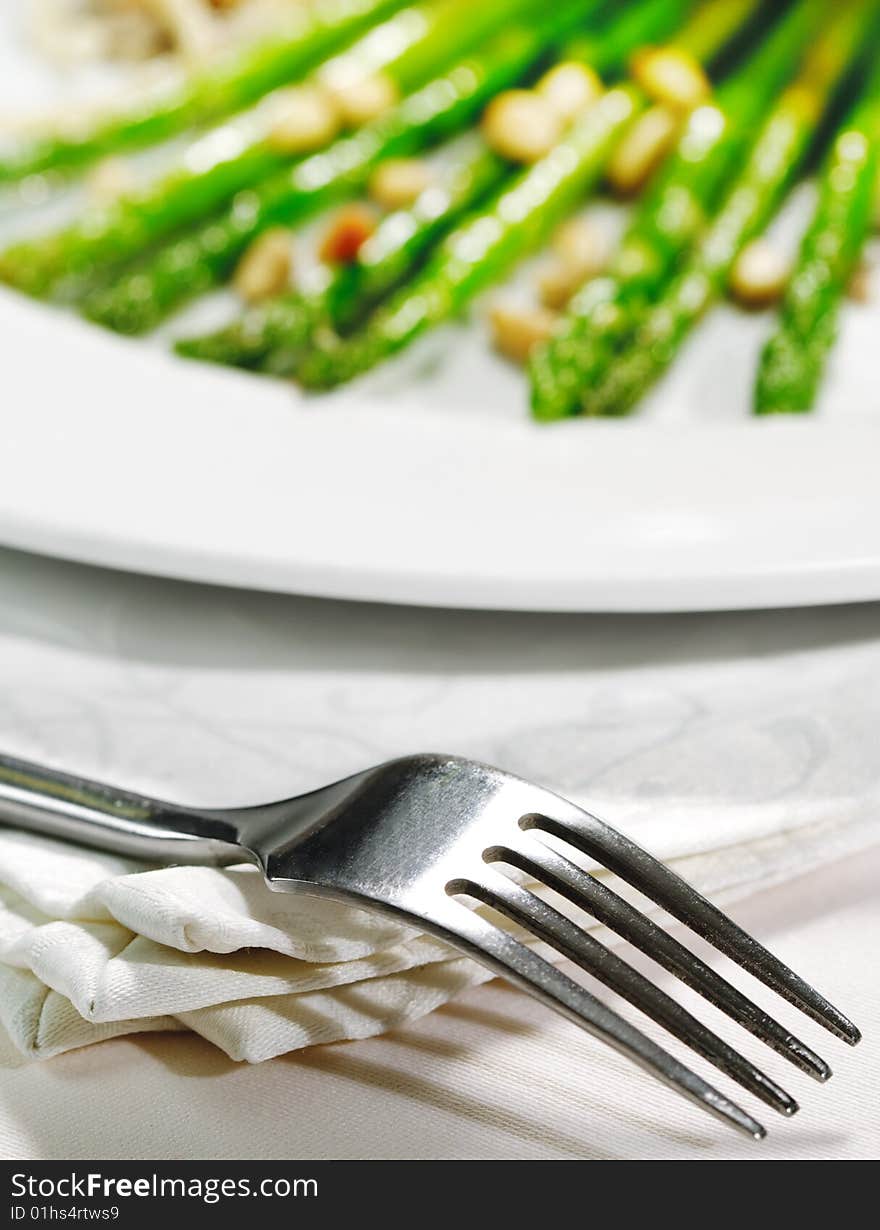 Fork and Fresh Asparagus on a Background. Selective Focus