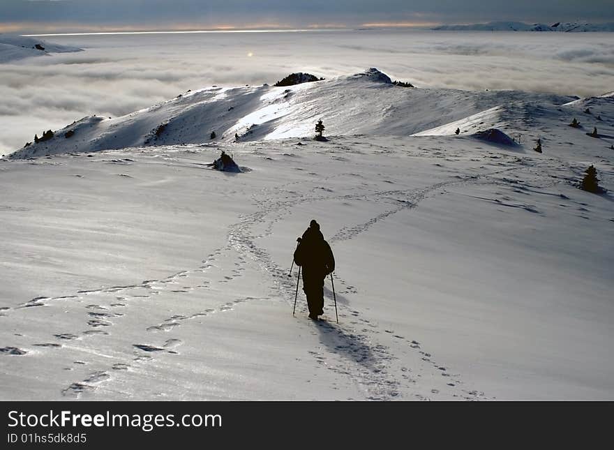 Silhouettes hiking on the top of a romanian mountain, Ciucas, and walking towards the horizon. Silhouettes hiking on the top of a romanian mountain, Ciucas, and walking towards the horizon.