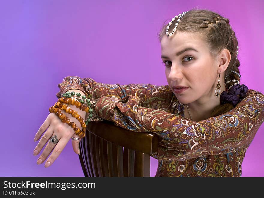 Nice young belly-dancer in ethnic indian dress against violet background. Nice young belly-dancer in ethnic indian dress against violet background