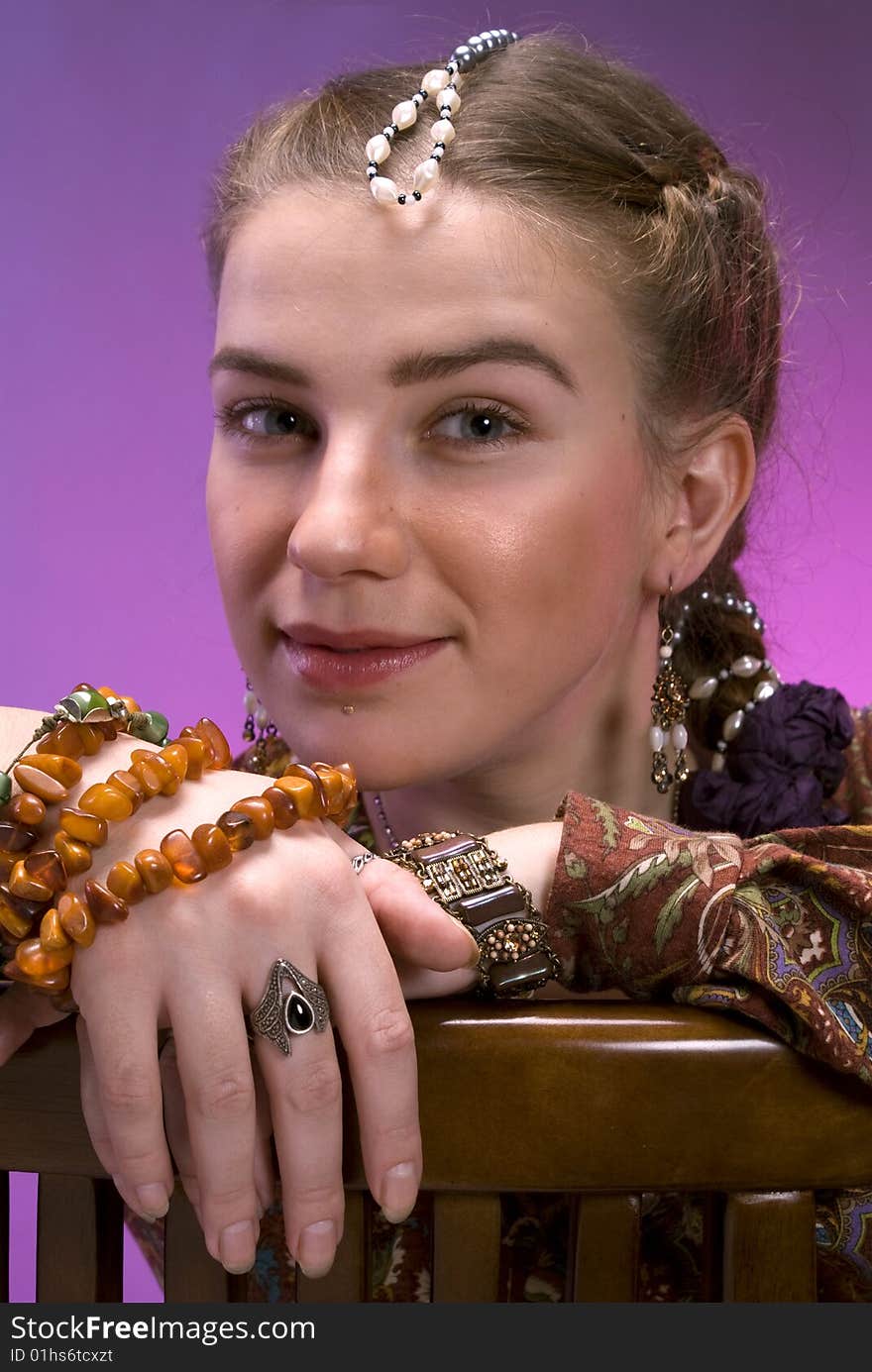 Portrait of nice young girl against violet background