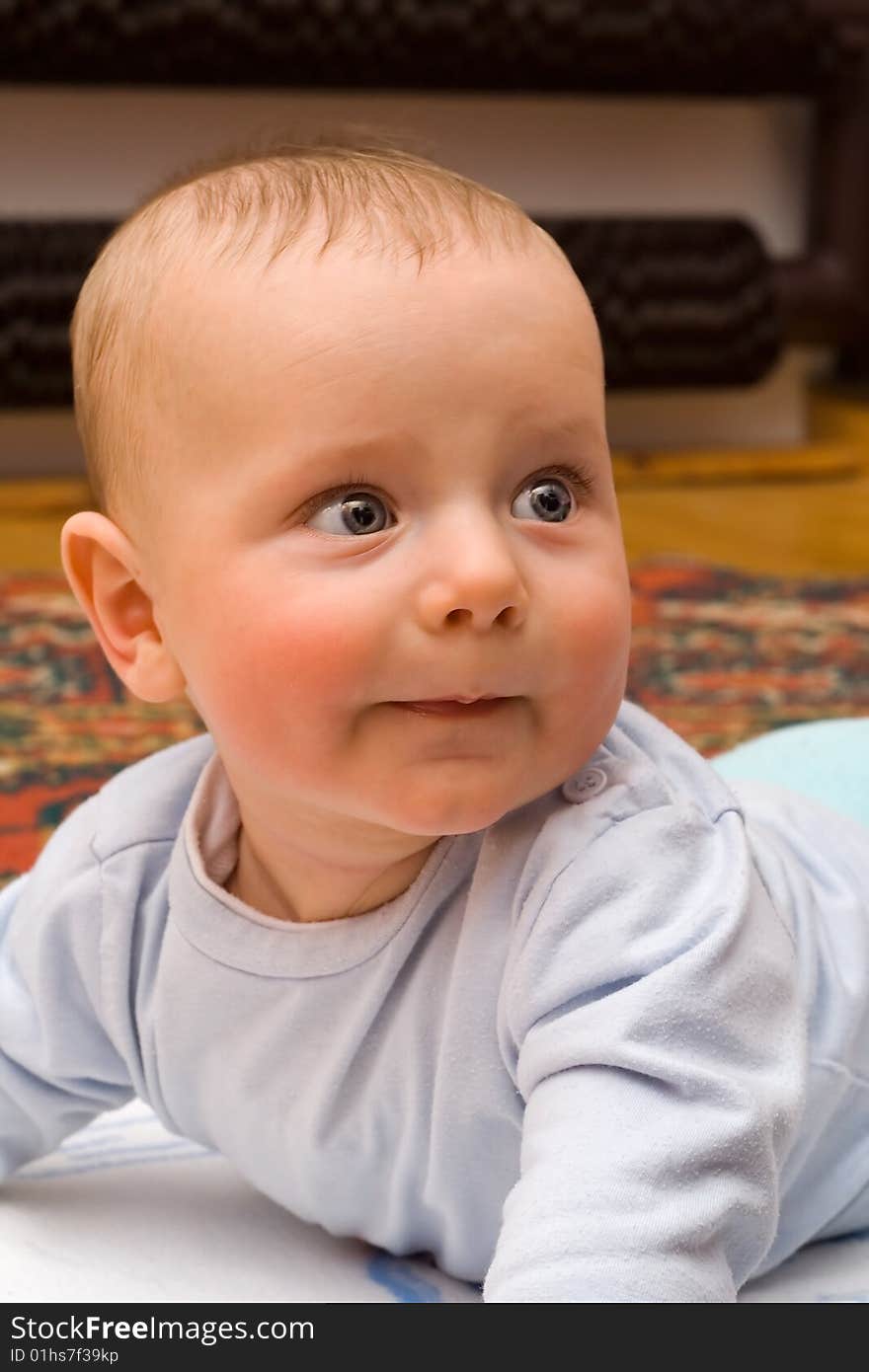 Caucasian infant raising his head