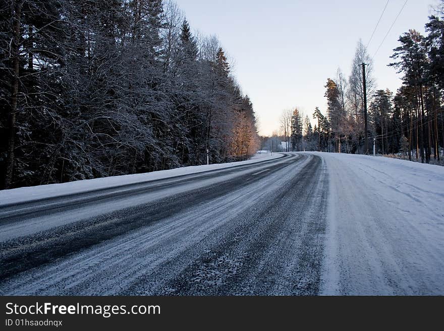 Winter road in evening wood