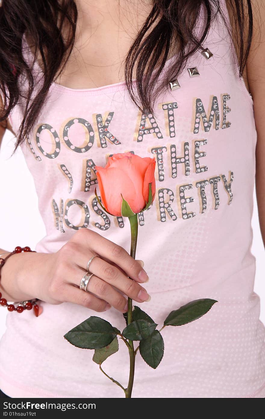 A girl holds a pink rose. A girl holds a pink rose.