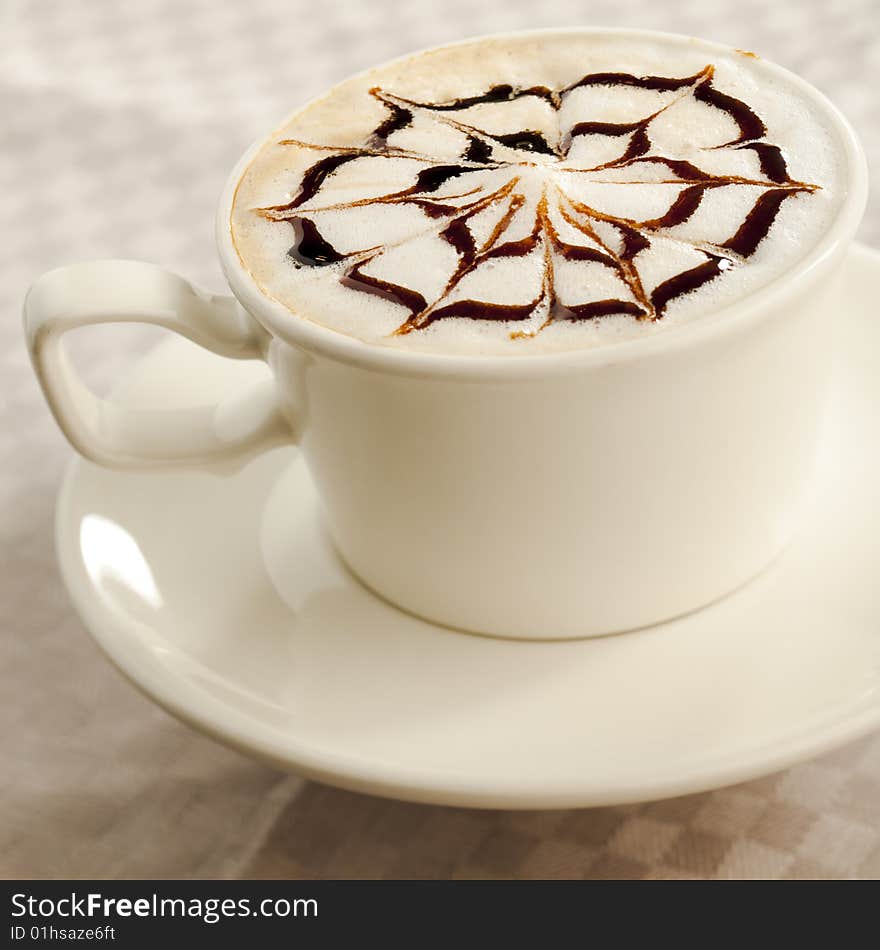 Coffee cup with chocolate web on top